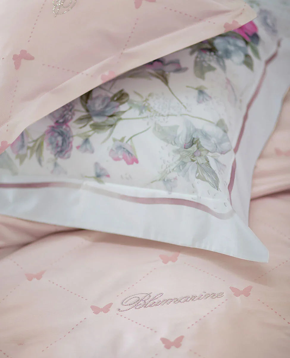 Lenzuola rosa Blumarine con ricami di farfalle e federa con stampa floreale elegante